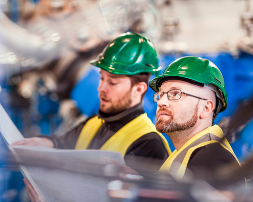 men-in-hardhats-reviewing-docs